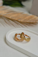 Gold-toned twisted hoop earrings with sleek interwoven design showcasing fine jewelry in 18k gold for elegant style