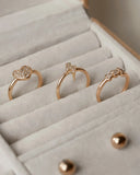 Three rose gold art gold jewelry rings with diamond heart lightning bolt and bow designs in Everett MA store.