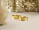 Two gold-toned wedding bands with sleek modern design and polished finish featured in everett jewelry store article on engagement rings.