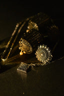 Gold filigree earrings with intricate sunburst patterns and dangling beads showcasing rinaldo borges fine jewelry craftsmanship