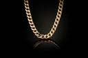 A sleek gold-toned 18k gold curb link chain necklace with a polished finish featured in fine jewelry trends