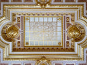 The ornate ceiling with gold filigree and gilded moldings complements art gold jewelry collections in local Everett stores.
