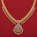Gold jewelry necklace with intricate woven design, pearls, diamonds, and a vibrant red gemstone pendant in fine art gold style.