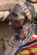 A vibrant beaded headband with geometric patterns in red yellow blue and white inspired by fine jewelry history.