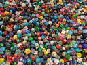 Colorful polyhedral dice resembling cursed Hope Diamond royal jewels