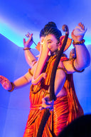 A statue of lord ganesha holding a bow and conch.