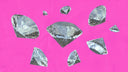 Faceted silver diamonds scattered on vibrant pink background illustrating fine jewelry and art gold history.
