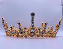A golden tiara with dark blue and clear crystals showcasing exquisite art gold jewelry in royal crown jewels evolution