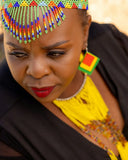 Woman wearing colorful beaded headdress and jewelry