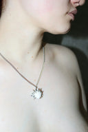 a close up of a person wearing a necklace