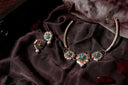 Gold-toned art gold jewelry floral necklace and earrings with green enamel and pearl accents in lost royal jewels article