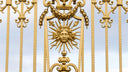 Stunning 18k art gold jewelry gate with sun emblem and scrollwork
