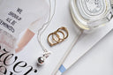 Silver bell pendant necklace with toggle clasp and delicate chain showcasing fine jewelry in 18k gold care tips.
