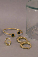 three rings and a glass on a table