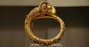 Gold snake bracelet with intricate scrollwork in art gold jewelry