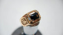 Gold ring with black gemstone and masonic symbols