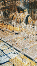 A display of gold jewelry featuring 18k gold and silver necklaces rings and bracelets with turquoise accents