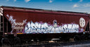 Graffiti art covers a brown train car