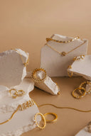 Gold-toned engagement ring with textured beaded band and clear stones showcasing ethical jewelry craftsmanship.