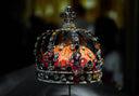 Authentic crown jewels with orange velvet interior and luxury jewelry gems.