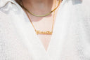 Gold-colored blessed nameplate necklace with sleek thin chain crafted as fine 18k gold jewelry in Massachusetts.