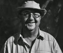grayscale photo of man wearing hat and button up shirt