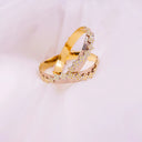 Gold bangle with intricate floral and ribbed design featured in heirloom gold and diamond jewelry care tips at Everett jewelry store.