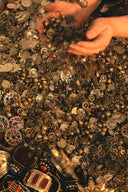 Hands shower glittering gold coins and jewels.