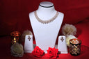 a white mannequin with red roses and jewelry on it