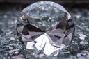 a diamond sitting on top of a pile of glass