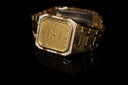 Gold-toned rectangular watch with diamond accents and quartz movement showcasing fine art gold jewelry aesthetics.
