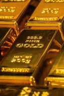 Shiny gold bars engraved with 999.9 fine gold and 2365 grams highlighting gold jewelry purity in 18k gold vs 14k gold article