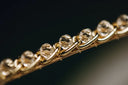 a close up of a gold chain with diamonds