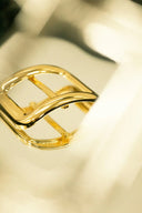 Stunning 18k gold belt buckle with sleek curves and polished edges