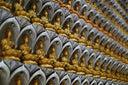a wall full of gold buddha statues in a store