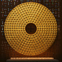 Circular golden disc with many small lights