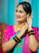 Woman in vibrant saree with stunning 18k gold jewelry and art gold jewelry