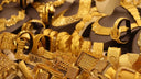 A collection of intricately designed 18k gold jewelry including necklaces and bracelets showcasing fine jewelry trends