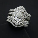 Dazzling pear-shaped diamond ring in platinum with pave bands