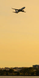 A large jetliner flying through a cloudy sky