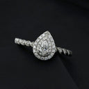 A sparkling pear-shaped diamond engagement ring with double halo and twisted white gold band from everett jewelry store.
