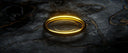 Glowing 14k gold mens ring on dark marbled stone