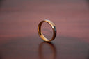 A sleek 18k gold jewelry men’s ring with polished two-tone finish and subtle engraved detailing for heirloom style.