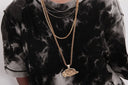 Gold chain necklace featuring a detailed textured hat-shaped pendant in art gold fine jewelry style for stylish layering.