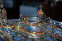 Silver ornate crown jewels adorned with red gemstones and central religious icon showcasing fine jewelry craftsmanship