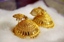 Gold jewelry featuring golden filigreed jhumka earrings with traditional conical design and dangling beads for art gold jewelry fans