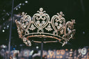 An ornate gold tiara with intricate diamond settings and heart motifs featured in mysterious adornments at everett jewelry store