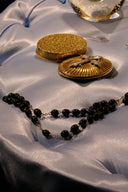 Gold ornate compact with textured lid and decorative cross centerpiece featured in mystery of lost royal gold jewelry