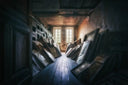 Stacks of ornate frames with lost treasures against attic walls
