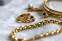 Gold cartier love bracelet with black onyx and diamond accents showcasing art gold jewelry symbolism